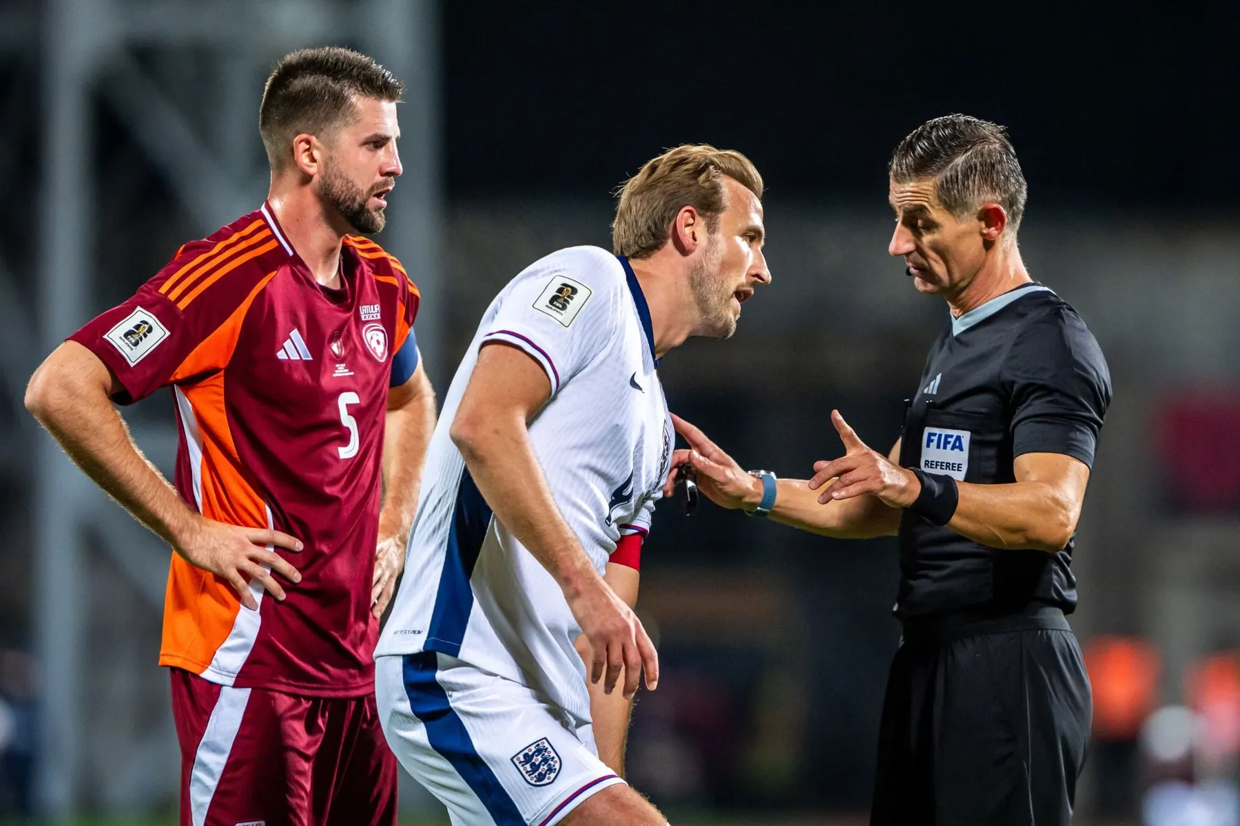 Latvia's captain talking with the referee during a match